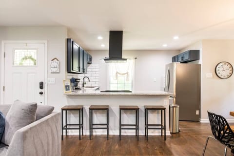 Modern Home with Chic Blue Spacious Kitchen and open concept living room.