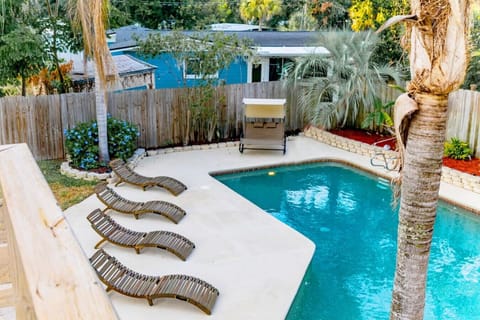 Outdoor saltwater pool has plenty of seating to soak up the sun