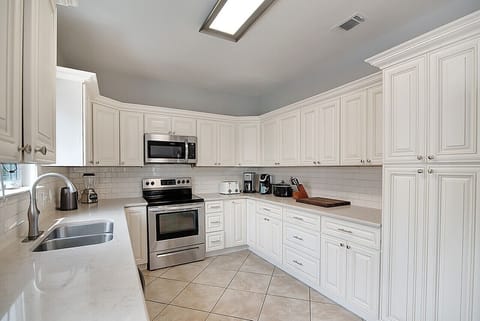 The spacious kitchen has plenty of cabinet and counter space for meal prep