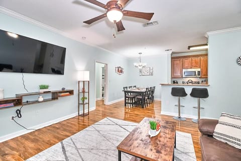 Experience ultimate comfort in the living room with a sofa, TV, TV cabinet, ceiling fan, and a lamp