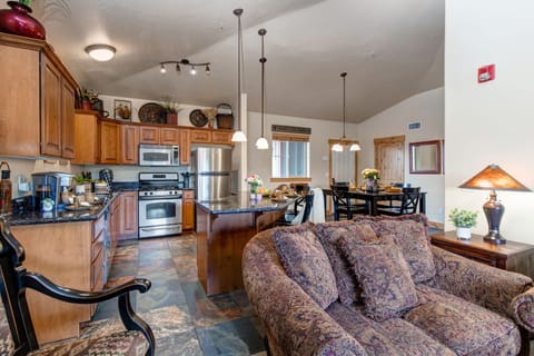 Living Room with plush sofa & loveseat, gas fireplace, 50" TV, and private deck access