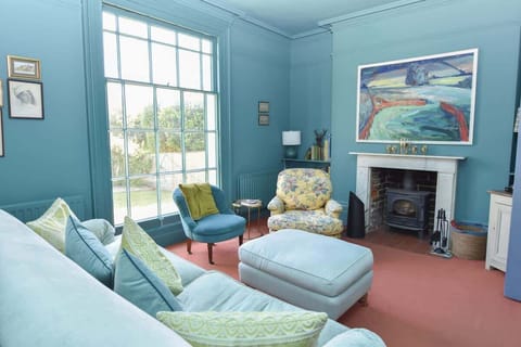 A secondary snug on the ground floor with armchairs and garden views—perfect for a quiet escape.