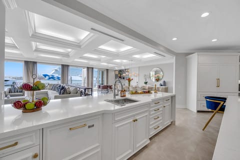 The gourmet kitchen opens on the dining room with seating for ten featuring incredible views of the inlet.