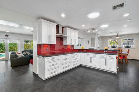 Kitchen opens onto breakfast bar and dining room.