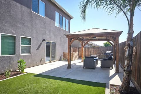 Beautiful backyard and gazebo with outdoor dining, fire pit, and BBQ with propane.