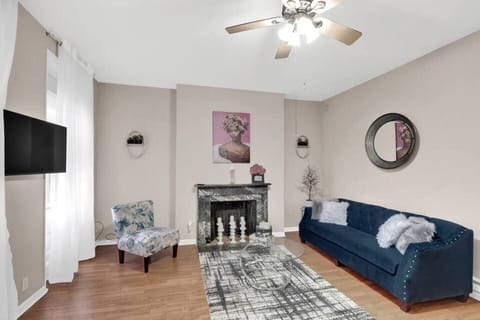 Lovely living room w a comfortable couch, 43” smart TV, dining area seats 6, and decorative fireplace. 