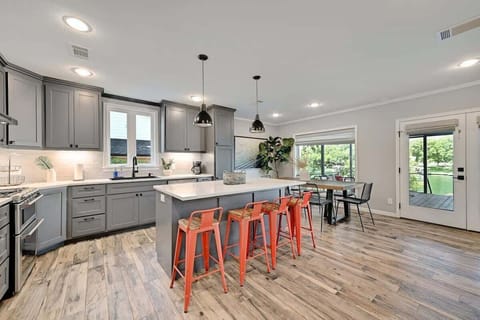 The kitchen offers a breakfast bar and seating for 8 at the dining table