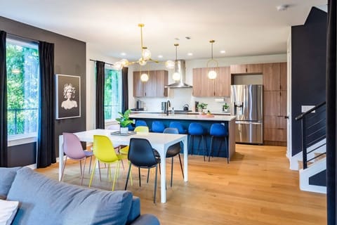 Spacious Kitchen And Dining Area With Modern Design And High Chairs By The Island