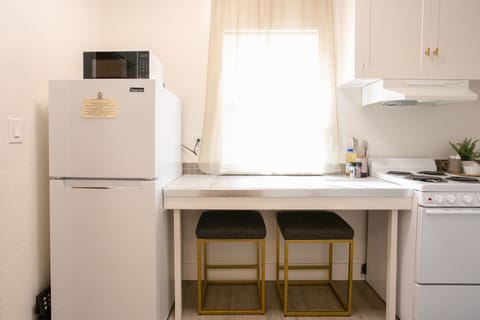 Enjoy a cozy dining spot with modern stools and natural lighting.