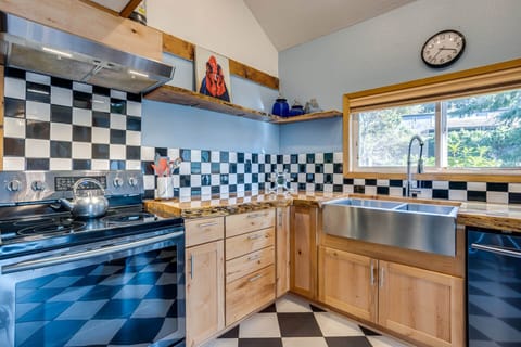 Large, fun kitchen with a view of the yard.