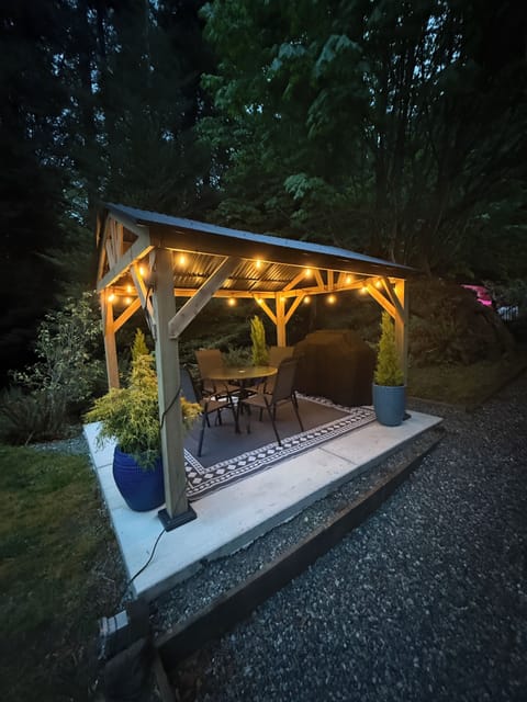 Private gazebo next to the apartment door which includes a gas grill