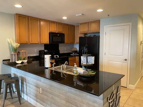 Kitchen area is well equipped with a refrigerator with ice in the door.  Fully stocked kitchen with cookware, crock pots and both a regular brew coffee maker and a Keurig maker. 