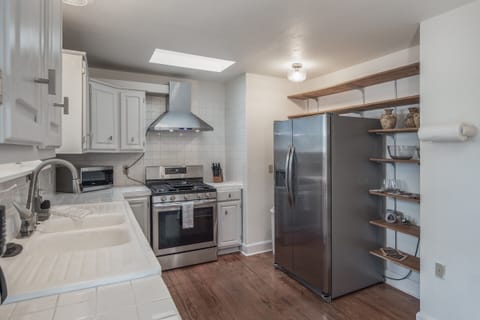 Fully furnished kitchen with microwave, stove, oven fridge and pantry.