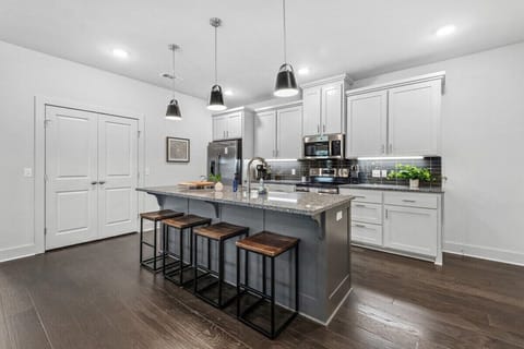 To the right, you'll see our open-concept kitchen, which is fully stocked with everything you need to cook your favorite meals.