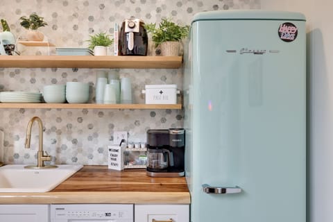 A mint green retro style fridge fits perfectly in this gorgeous kitchen 