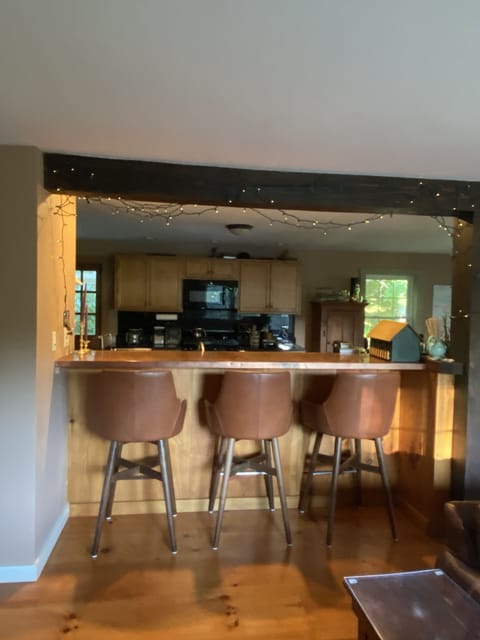 Copper bar/seating area with comfortable barstools.  


