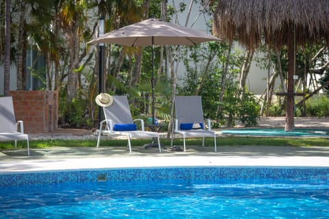 Lounges and shades around our swimming pool