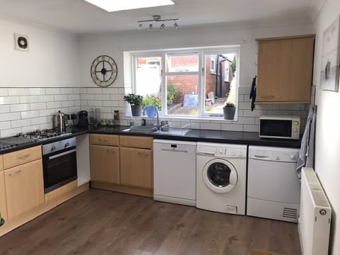 Washing machine and tumble dryer. Retractable washing line available in garden.