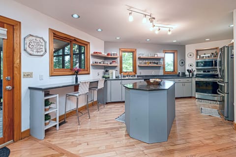 Fully stocked kitchen, island, eating area. Large fridge w/ice maker, appliances