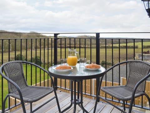 Seating on balcony commands panoramic views | Rhiwal Kitty - Trehwfa Cottages, Bodedern, near Holyhead