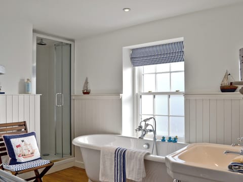 Light and airy bathroom with roll-top bath and separate shower cubicle | Tides, Cromarty