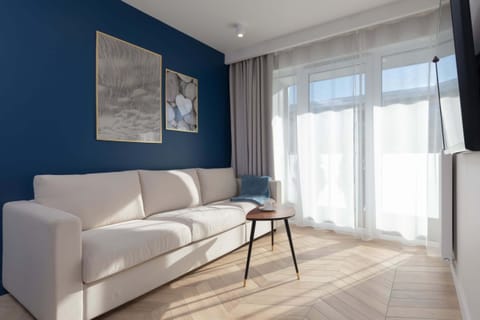 A cozy and modern living room with large windows that let in plenty of natural light, emphasizing the unique character of the room.
