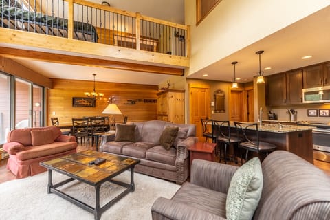 Living area featuring a fireplace, cozy furnishings, and a mounted Smart TV + DVD player.