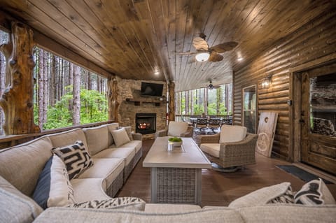 Relax on the large back patio featuring a smart TV over a gas fireplace.