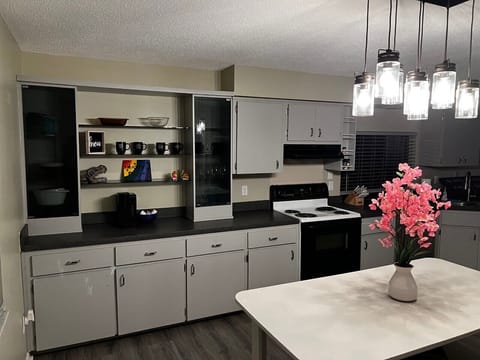 Fully equipped kitchen with pots, pans, silverware, cooking utensils and Keurig.