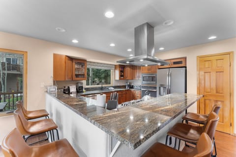 Full-sized luxury kitchen with breakfast bar seating for casual dining.
