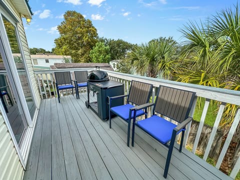 Outdoor area with grill and additional outdoor seating