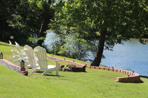 sitting area with firepit overlooking the water. 