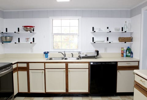 Full Kitchen with dish washer and open shelving for easy access.