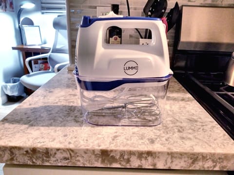 Electric Hand Mixer Located In Cabinet Below