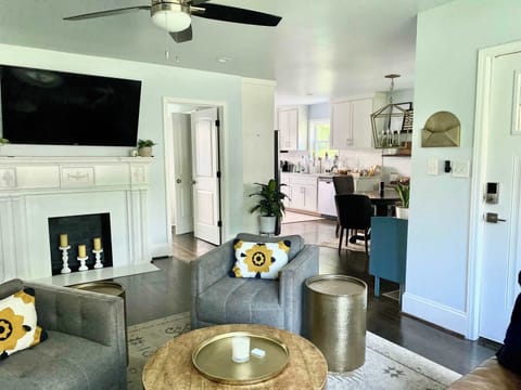 Modern living room with comfy seating and an open kitchen, ideal for relaxing and entertaining
