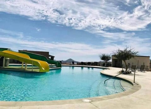 Dive into fun with the outdoor pool, featuring a thrilling waterslide that adds an extra splash of excitement. Perfect for both relaxation and play, this inviting pool area offers plenty of space for lounging and enjoying the sun. Whether you’re slid