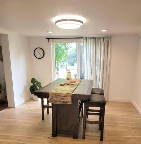 Dining area that fits 6. There are folding chairs to add to this table. There is a table right outside this door that can be brought into kitchen on a rainy day or guest can eat on the patio. 