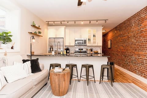 Four-seater dining table in the living area, perfect for enjoying meals or gathering with friends.