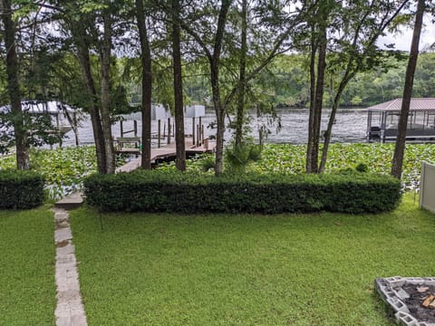 view of backyard, boat dock, and river