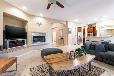 Living room showing the kitchen with modern appliances.