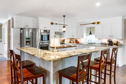 Large, open concept kitchen that opens to living and dining area upstairs