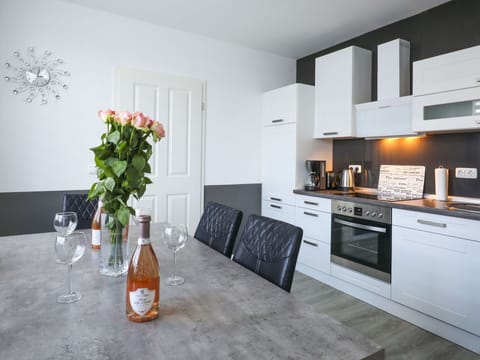 Furniture, Cabinetry, Property, Flower, Countertop, Bottle, Interior Design, Orange, Plant, Kitchen Stove