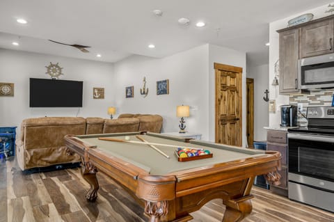 Game area with pool table and 70" smart TV