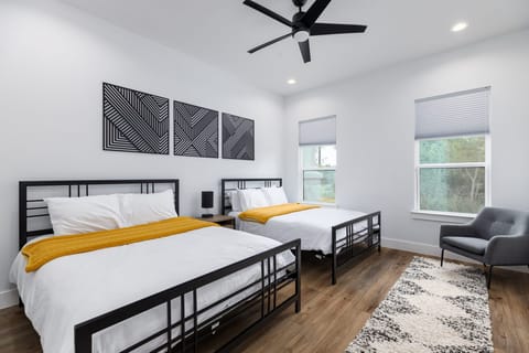 Bedroom 3 with two queen beds and plush linens for restful sleep