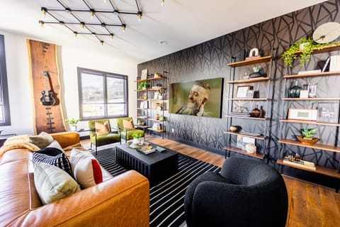 Unit 1: Extremely detailed spacious living area with designer luxury furnishings, 85 in flat screen TV, flooring from a 150 year old barn, custom murals/wall art, light fixtures and wall paper.