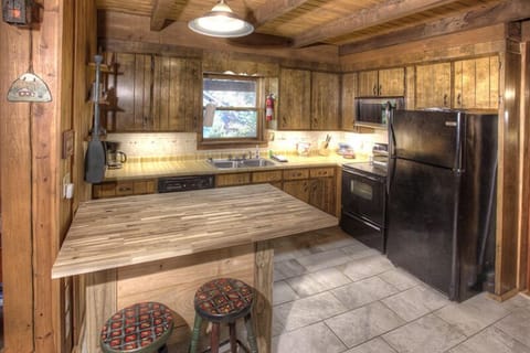 Kitchen with serving bar and stools