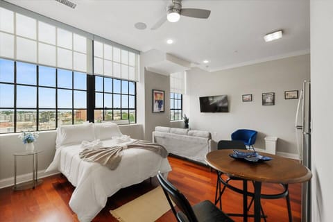 Spacious Northern Liberties studio with floor-to-ceiling windows, motorized shades, full kitchen, and modern bathroom.