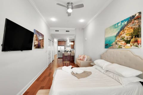 Spacious Northern Liberties studio with queen bed, full kitchen, modern bathroom, and floor-to-ceiling windows throughout.