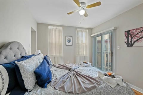Comfortable private bedroom with queen size bed, plus linens and pillows, plenty of sunlight and ceiling fan.