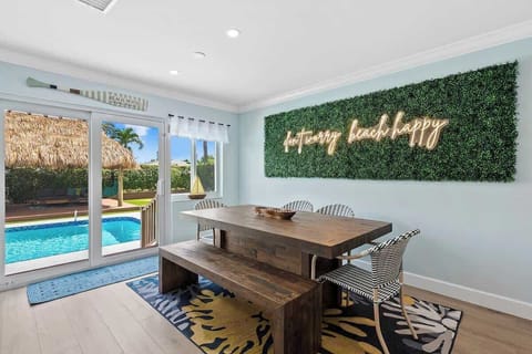 "Don't worry beach happy" is this house's motto!  Awesome neon sign in dining area looking out to pool and TIKI !
